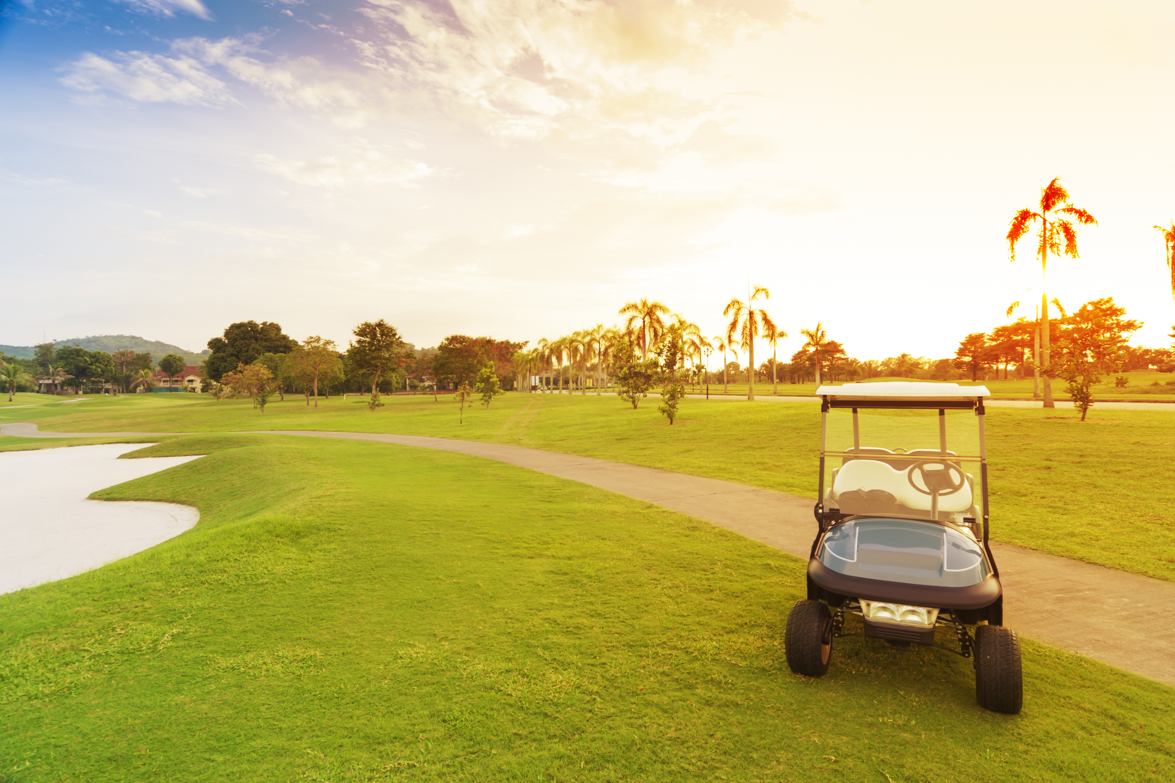 golf car with sun set in golf course.